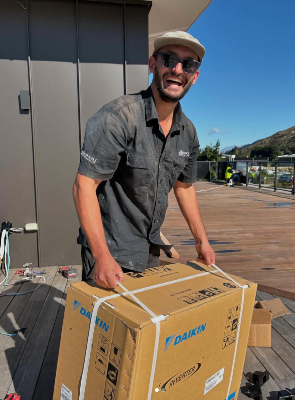 Shak from Remarks Refrigeration holding a Daikin Inverter box