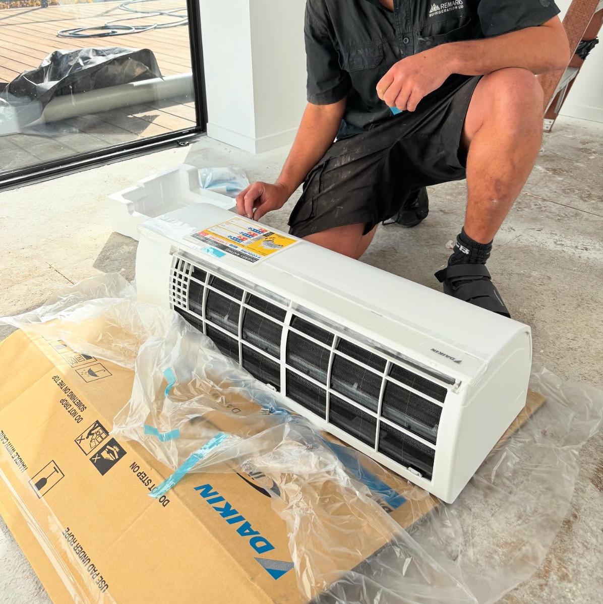 Remarks Refrigeration technician unpacking a new Daikin heatpump for installation